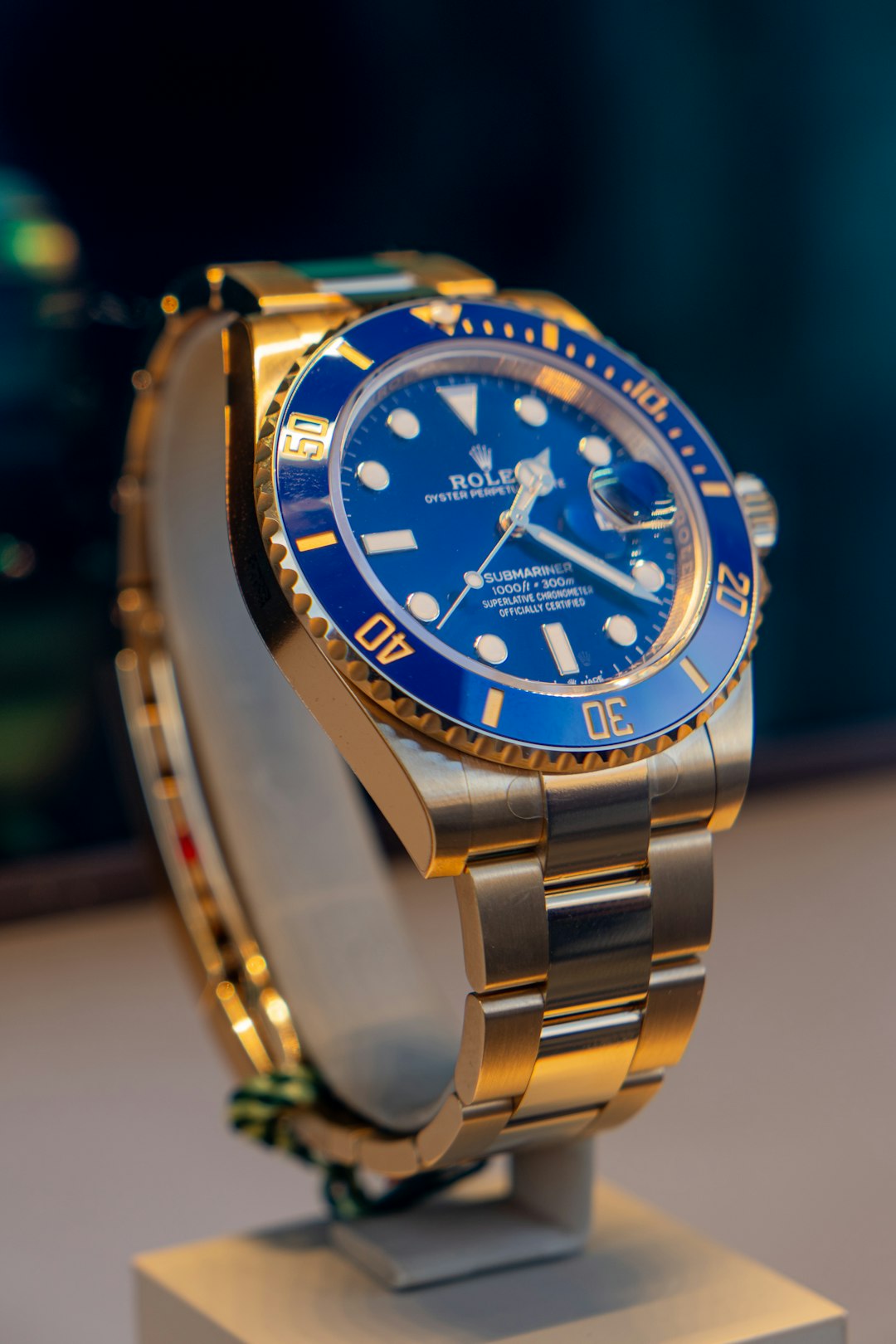 a-blue-and-gold-rolex-watch-on-a-stand-1f8wff4ysxc