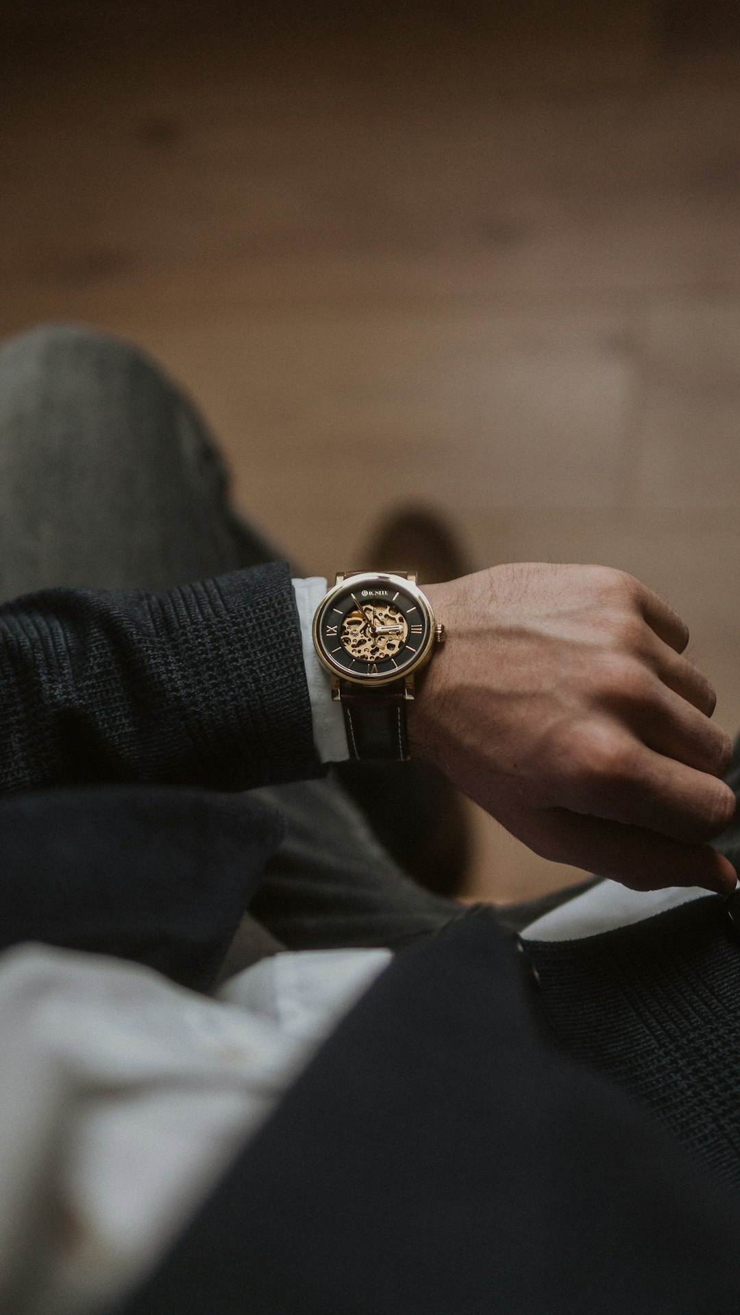 person-wearing-gold-and-silver-round-analog-watch-gj9b48mc5qs